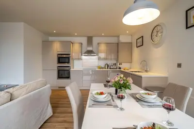 a kitchen and living room with a table and chairs at 2 King Georges - Aldeburgh Coastal Cottages in Aldeburgh