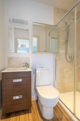 a bathroom with a toilet and a shower and a sink at 2 King Georges - Aldeburgh Coastal Cottages in Aldeburgh