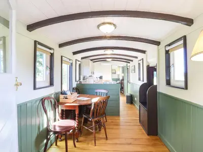 a dining room with a table and chairs at The Brake Wagon at High Barn Heritage in Halstead