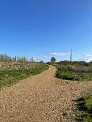 a dirt road in a field with a blue sky at Fully Detached Studio Annexe with King Bed for 2 & Sofa Bed for 2 in Cambourne