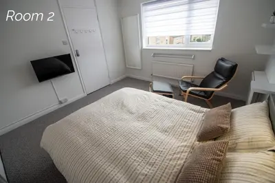 a bedroom with a bed and a chair and a window at Town House Chantry - With Self Check In and Free Parking - Rooms at ipswichdigs in Ipswich