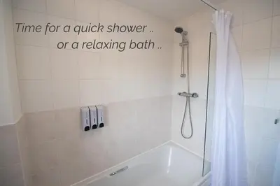 a bathroom with a shower with a shower curtain at Town House Chantry - With Self Check In and Free Parking - Rooms at ipswichdigs in Ipswich