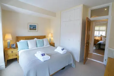 a bedroom with a large bed with towels on it at The Hideaway, Aldeburgh in Aldeburgh