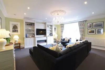 a living room with a couch and a tv at Regatta Lookout in Aldeburgh