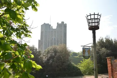 a street light with a tall building in the background at Vesta Cottage, Orford in Orford