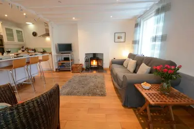 a living room with a couch and a table at Vesta Cottage, Orford in Orford