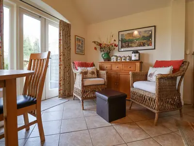 a living room with chairs and a table at Romulus in Roudham