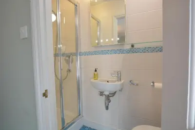 a bathroom with a sink and a shower at Bunny Cottage, Aldeburgh in Aldeburgh