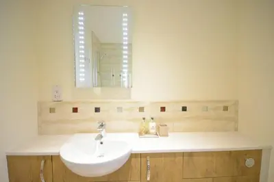a bathroom with a sink and a mirror at Red Robin, Whepstead in Whepstead