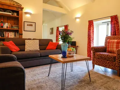 a living room with a couch and a table at Remus in Larling