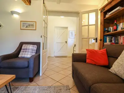 a living room with a couch and a chair at Remus in Larling