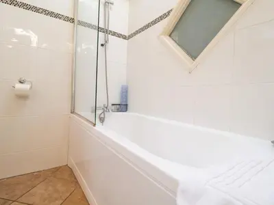 a bathroom with a bathtub and a mirror at Remus in Larling