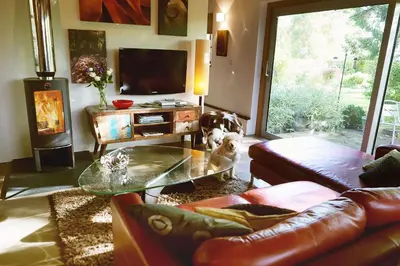 a living room with a couch and a glass table at Chobbs Barn, Eye in Eye