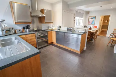 a kitchen with a sink and a stove top oven at Lavender House, Aldeburgh in Aldeburgh