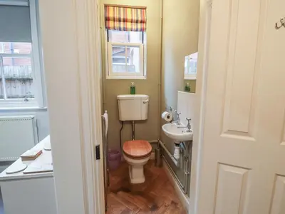 a small bathroom with a toilet and a sink at Lavender House, Aldeburgh in Aldeburgh