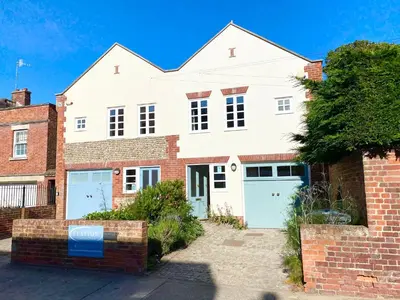 a large white house with two garage at Seawall Cottage, Aldeburgh in Aldeburgh
