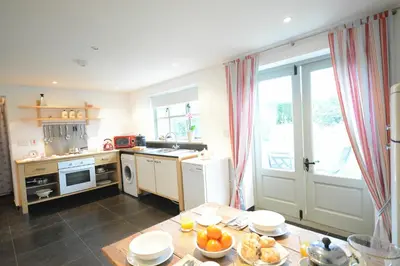 a kitchen with a table with food on it at 1 Grange Cottages, Westleton in Westleton