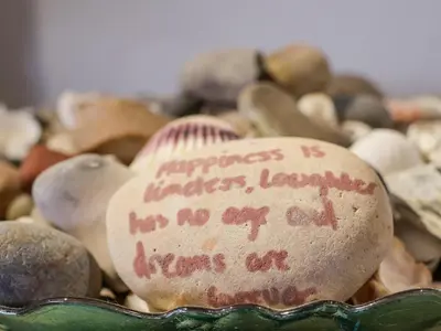 a rock with writing on it sitting in a pile of rocks at Lavender Cottage, Aldeburgh in Aldeburgh