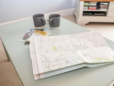 a table with a map and two mugs on it at Saffron, Blythview in Blythburgh