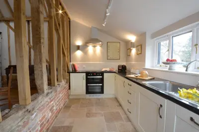 a kitchen with a sink and a counter top at Bird Cottage, Burgh in Grundisburgh