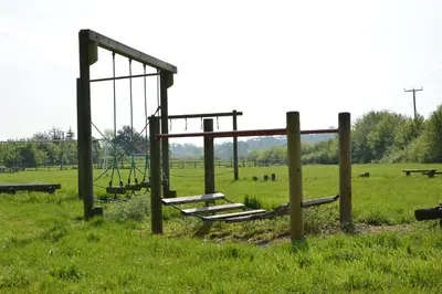 an empty playground in the middle of a field at 1 The Old Coach House in Laxfield