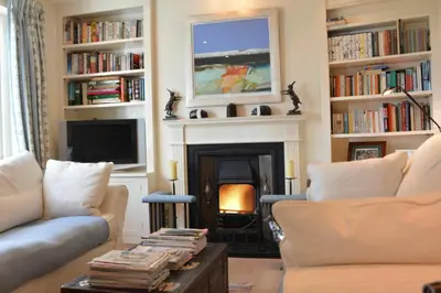 a living room with two couches and a fireplace at 2 The Bays, Thorpeness in Thorpeness