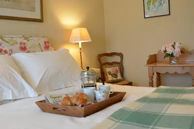 a tray of food and drinks on a bed at 2 The Bays, Thorpeness in Thorpeness