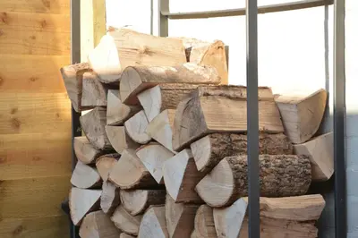 a pile of wood sitting next to a building at Little Turnpike Cottage, Melton in Woodbridge