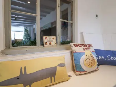 a room with a window and a pillow and a box at Pudding Cottage, Westleton in Westleton