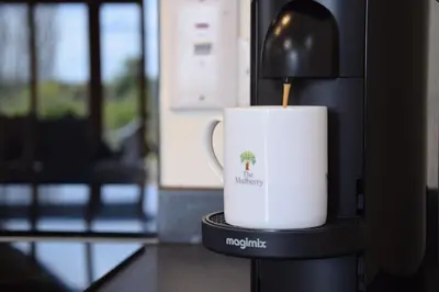 a coffee cup on top of a coffee machine at The Mulberry, nr Bungay in Bungay
