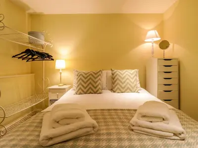 a bedroom with a bed with two towels on it at Quill Farm Barn in Campsea Ashe