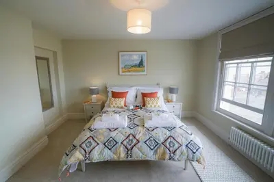 a bedroom with a bed and a window at 10 Church Walk, Aldeburgh in Aldeburgh