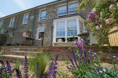 a house with purple flowers in front of it at 10 Church Walk, Aldeburgh in Aldeburgh