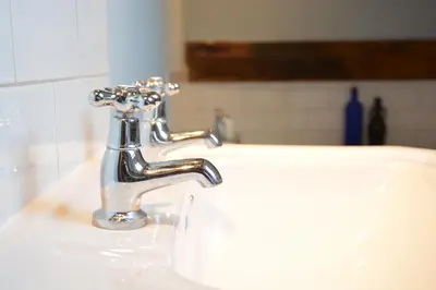 a bathroom sink with a silver faucet at Wheelwright's Barn in Halesworth