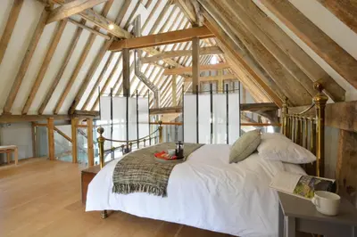 a bedroom with a white bed in a attic at Manor House Barn, Peasenhall in Peasenhall
