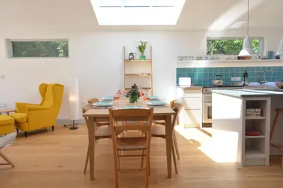 a kitchen and dining room with a table and chairs at 2 Pink Cottages, Aldeburgh in Aldeburgh