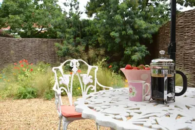 a table with a coffee maker on top of it at The Nookery at Snape Hall in Snape