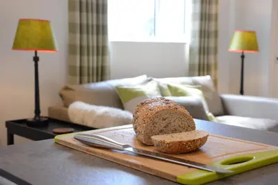 a loaf of bread on a cutting board on a table at Carriage House, Bruisyard in Framlingham
