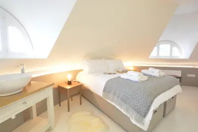 a bathroom with a bed with a sink and a sink at The Round House in Kettleburgh