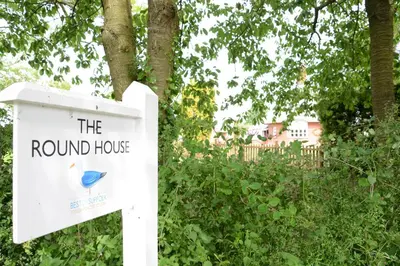 a sign for the round house with a blue bird on it at The Round House in Kettleburgh