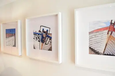 three framed photographs hanging on a white wall at 53 Tern Cottage, Aldeburgh in Aldeburgh