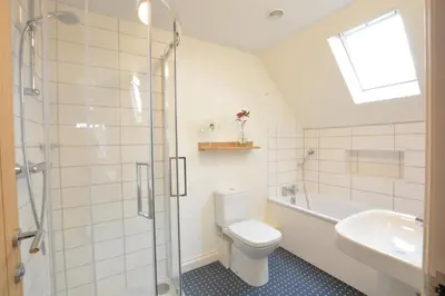 a bathroom with a toilet and a sink and a shower at Mellows, Thorpeness in Thorpeness