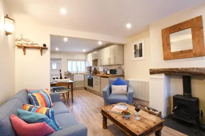 a living room with a couch and a table at Smugglers Rest, Aldeburgh in Aldeburgh