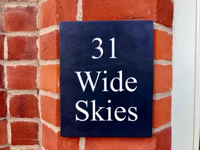a sign on a brick wall that reads wide skies at Wide Skies, Aldeburgh in Aldeburgh