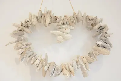 a heart shaped wreath of shells on a white background at Lapwings, Aldeburgh in Aldeburgh