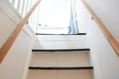 a staircase in a house with a window at The Moorings, Orford in Orford