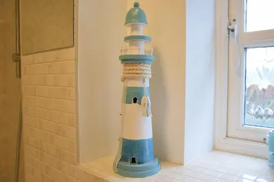a lighthouse decoration in the corner of a bathroom at Bluebelle Cottage, Peasenhall in Peasenhall