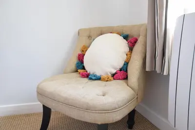 a stuffed animal is sitting in a chair at Satis Cottage, Westleton in Westleton