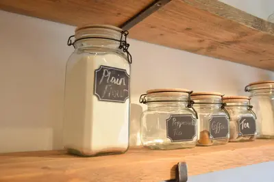 a shelf with four glass jars on it at Rosedene, Rickinghall in Rickinghall