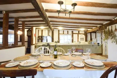 a table with plates and glasses on it in a kitchen at Church Farmhouse, Cookley in Halesworth